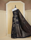 Black colour semi banaras tussar georgette saree featuring gold zari box pattern with motifs on body, finished with gold zari fancy border and paired with matching blouse piece.