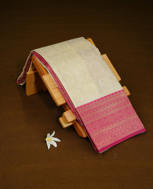 Cream Colour Semi Soft Silk Saree Featuring Gold zari Check With motifs Pattern On Body, Highlighted  by contrast Mauve border with Gold zari, paired with matching blouse piece.