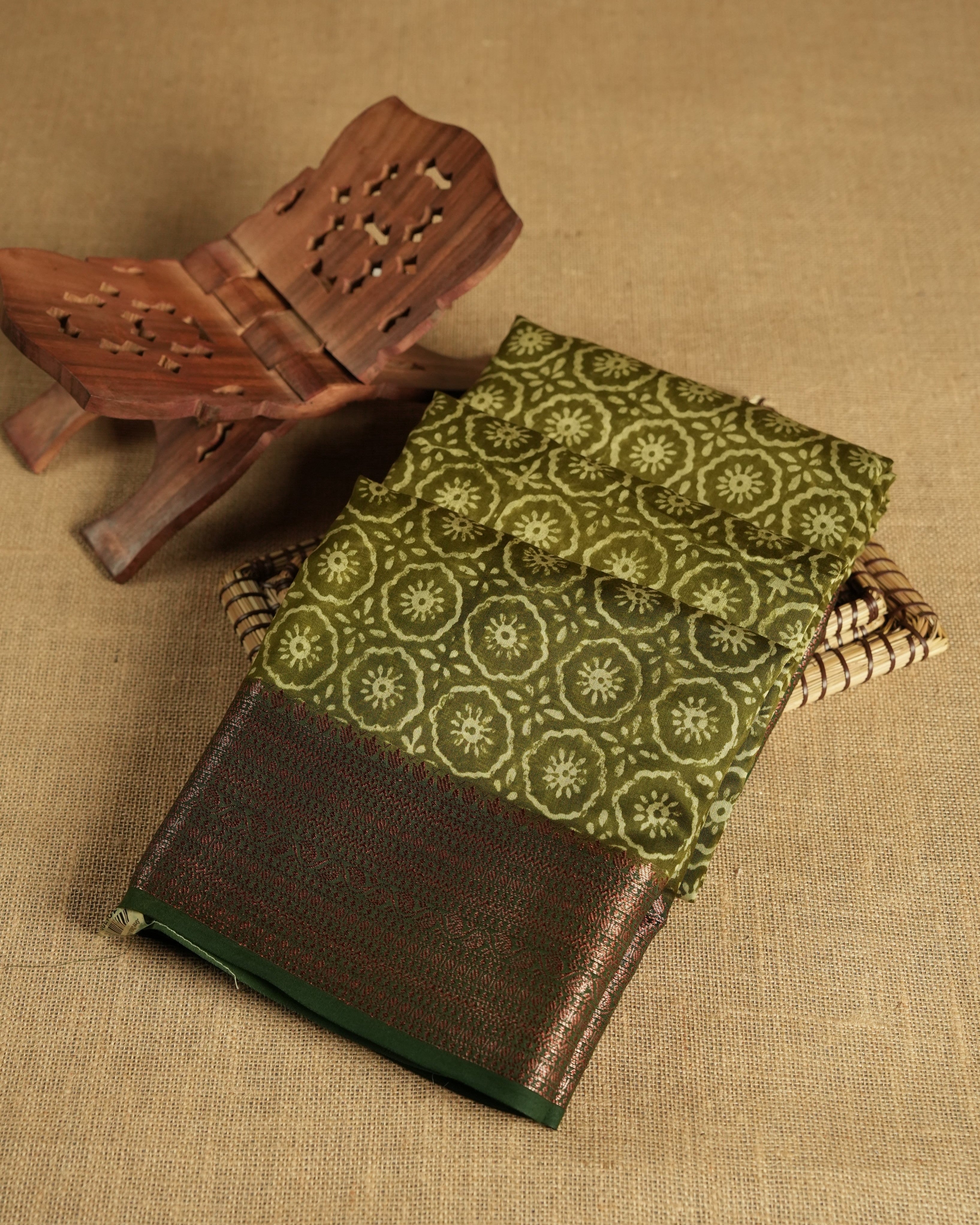 Olive colour chanderi silk saree with Floral block print On body, compilmented by  contrast dark green colour border with antique zari pattern and a matching blouse.