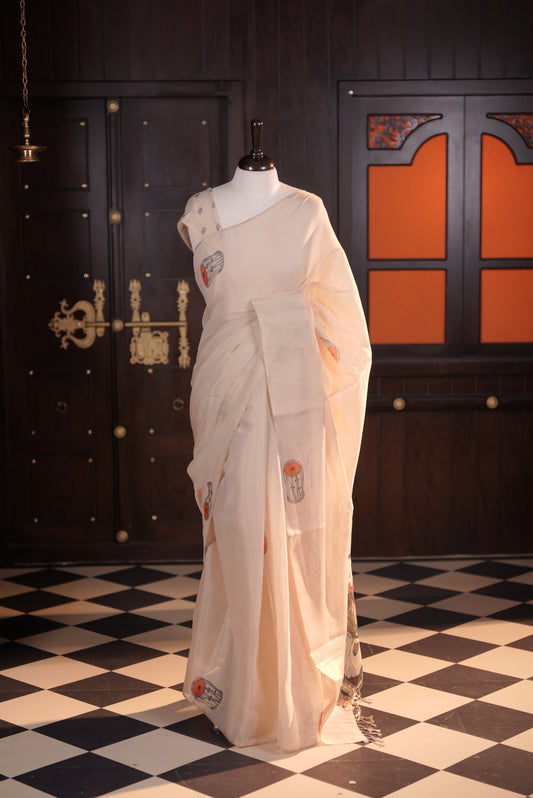 Beige colour semi linen tissue saree featuring instrument digital print throughout body, human printed pallu and small floral printed blouse piece.