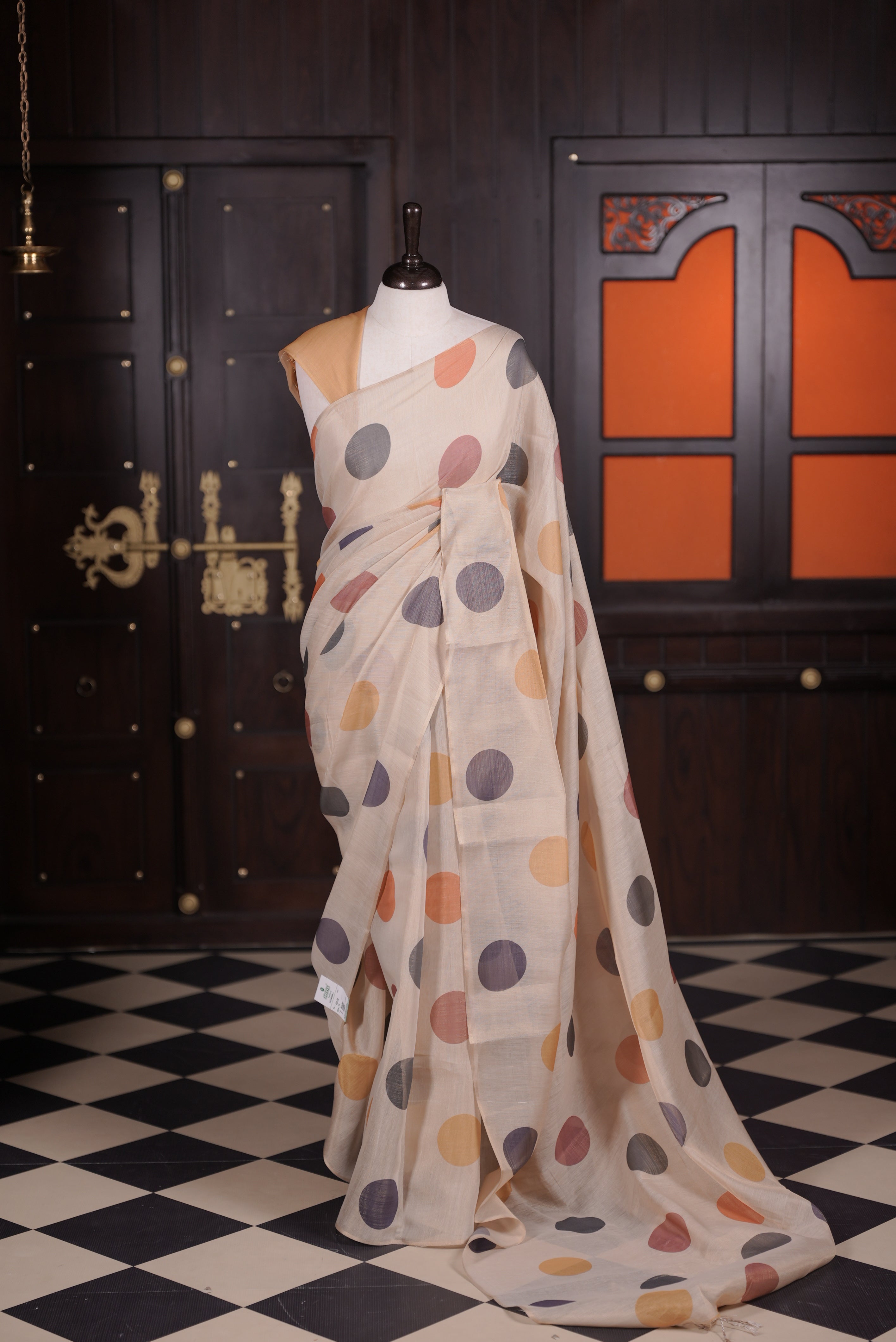 Beige colour semi linen tissue saree featuring multicolour bolga dot digital print throughout body, pallu and contrast yellow colour blouse piece.
