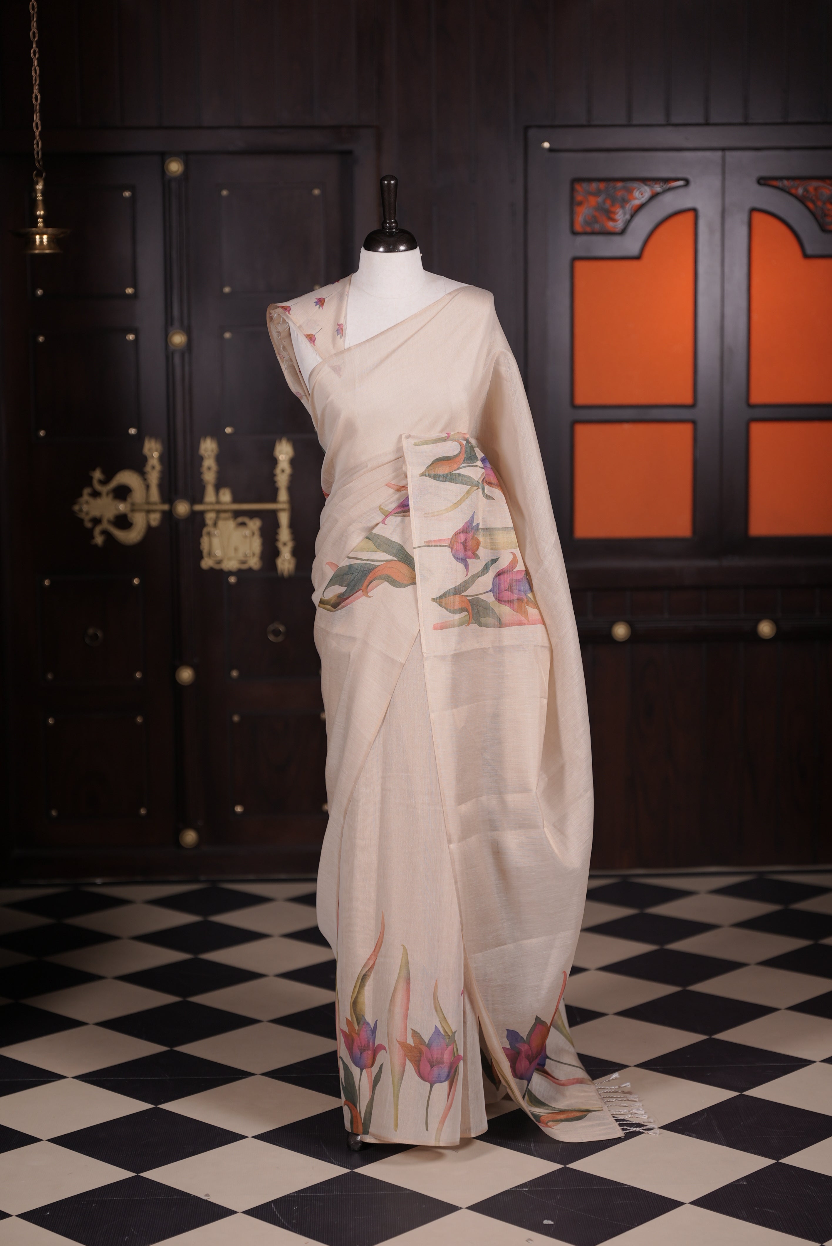 Beige colour semi linen tissue saree featuring floral digital print throughout body, running pallu with tassel and paired with matching blouse piece.