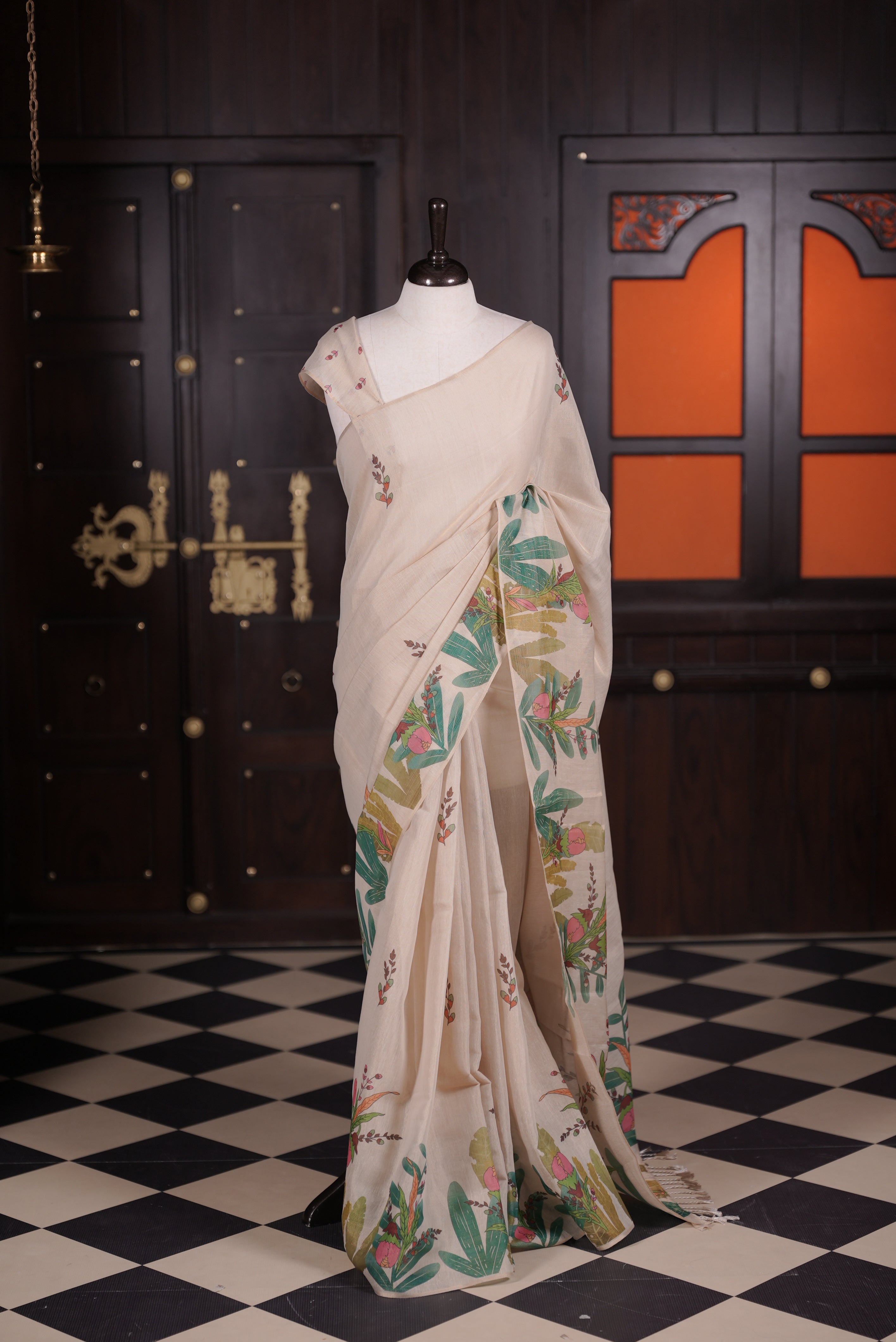 Beige colour semi linen tissue saree featuring Plant digital print throughout body, running pallu with tassel and paired with matching blouse piece.