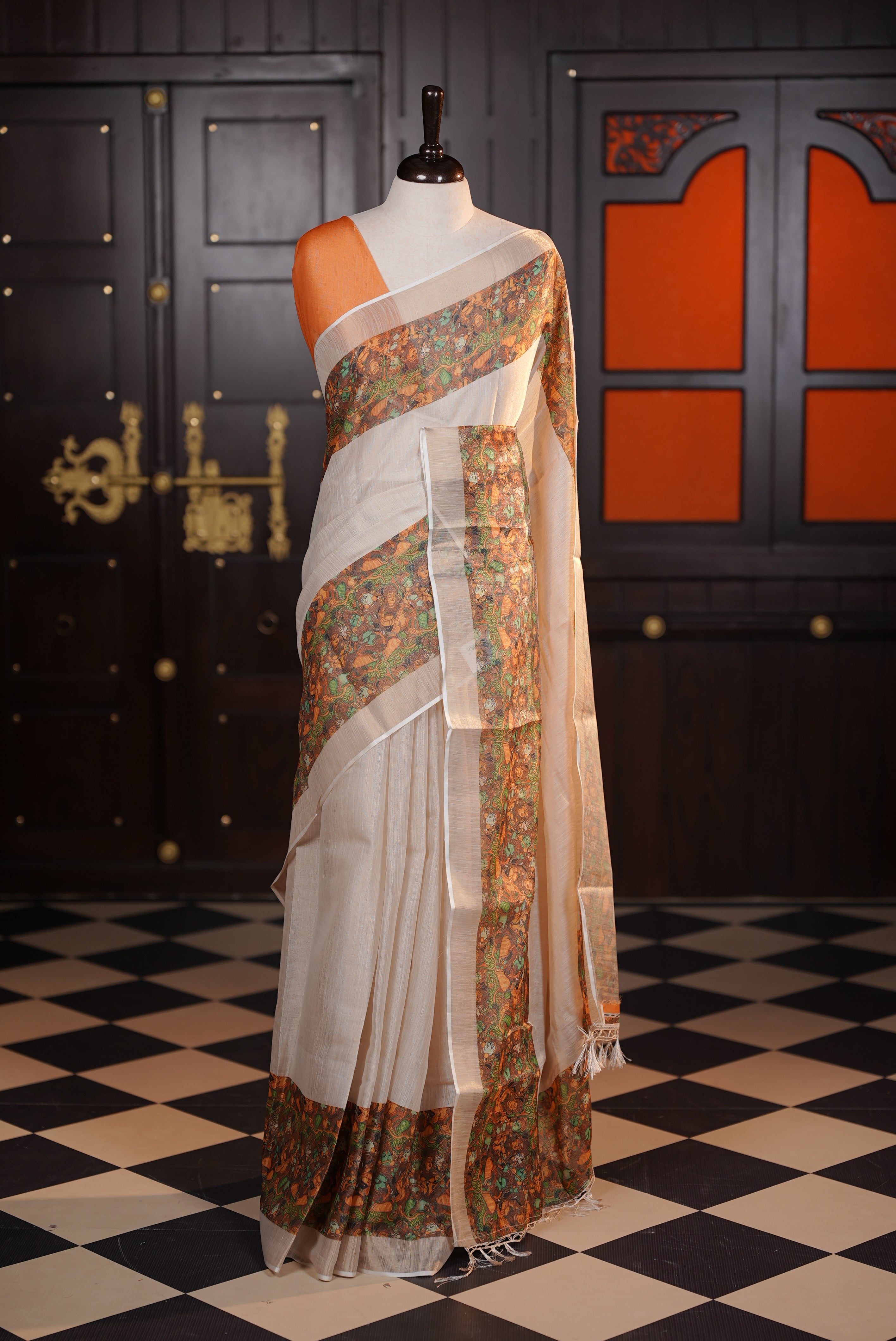 Light gold colour semi tissue silk saree with a Brown printed border, paired with a contrast blouse piece.