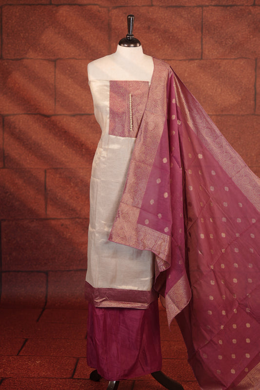 Rani Pink Colour Soft Tissue Salwar Material Featuring Elegant Beige Work On The Neck, Complemented By A Contrast Bottom And A Semi Banarasi Dupatta.
