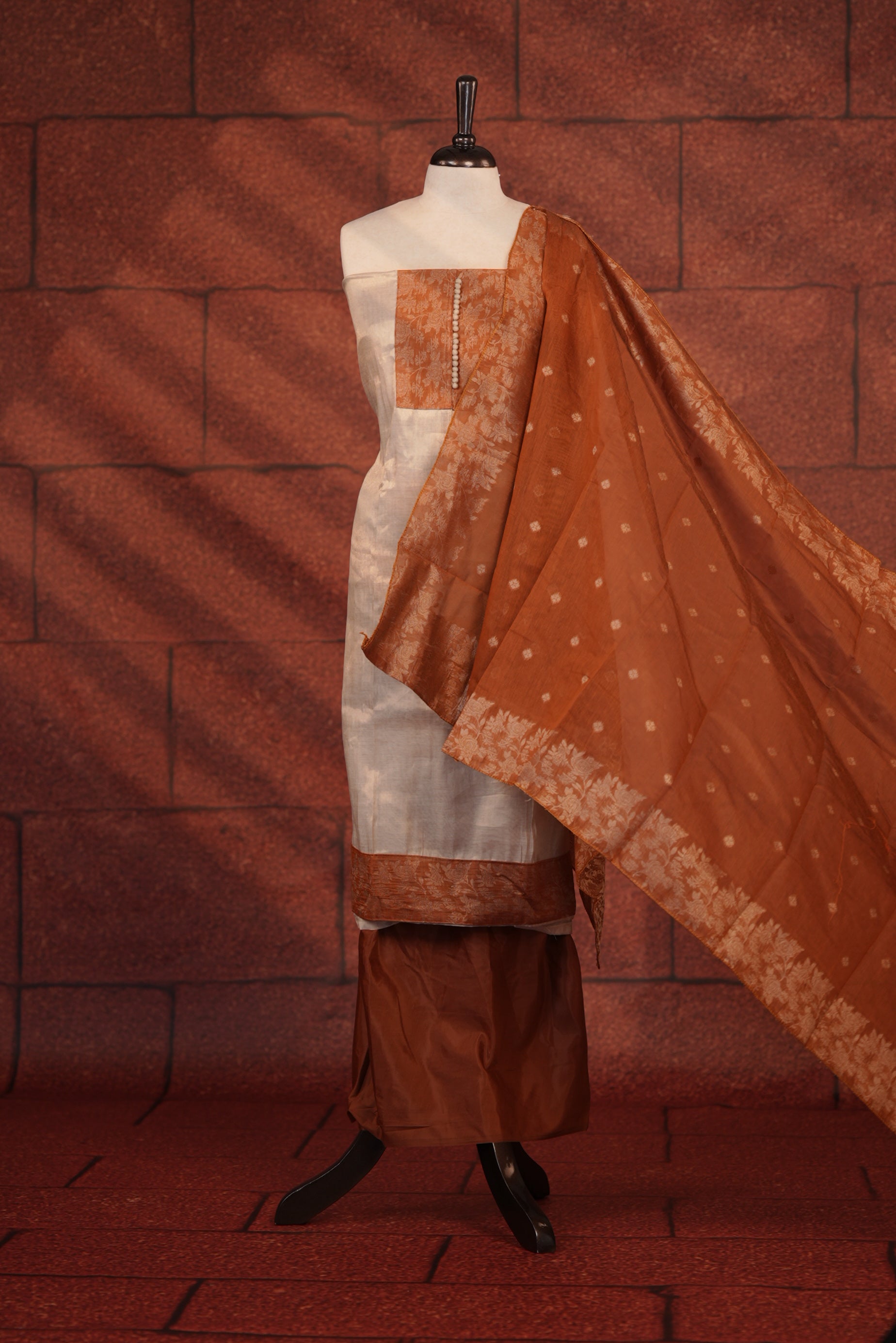 Rust Orange Colour Soft Tissue Salwar Material Featuring Elegant Beige Work On The Neck, Complemented By A Contrast Bottom And A Semi Banarasi Dupatta
