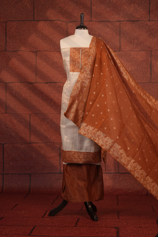 Rust Orange Colour Soft Tissue Salwar Material Featuring Elegant Beige Work On The Neck, Complemented By A Contrast Bottom And A Semi Banarasi Dupatta