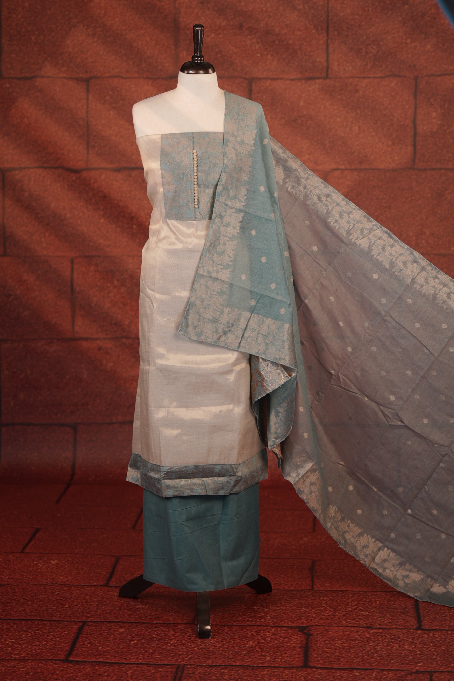 Teal Blue Colour Soft Tissue Salwar Material Featuring Elegant Beige Work On The Neck, Complemented By A Contrast Bottom And A Semi Banarasi Dupatta.