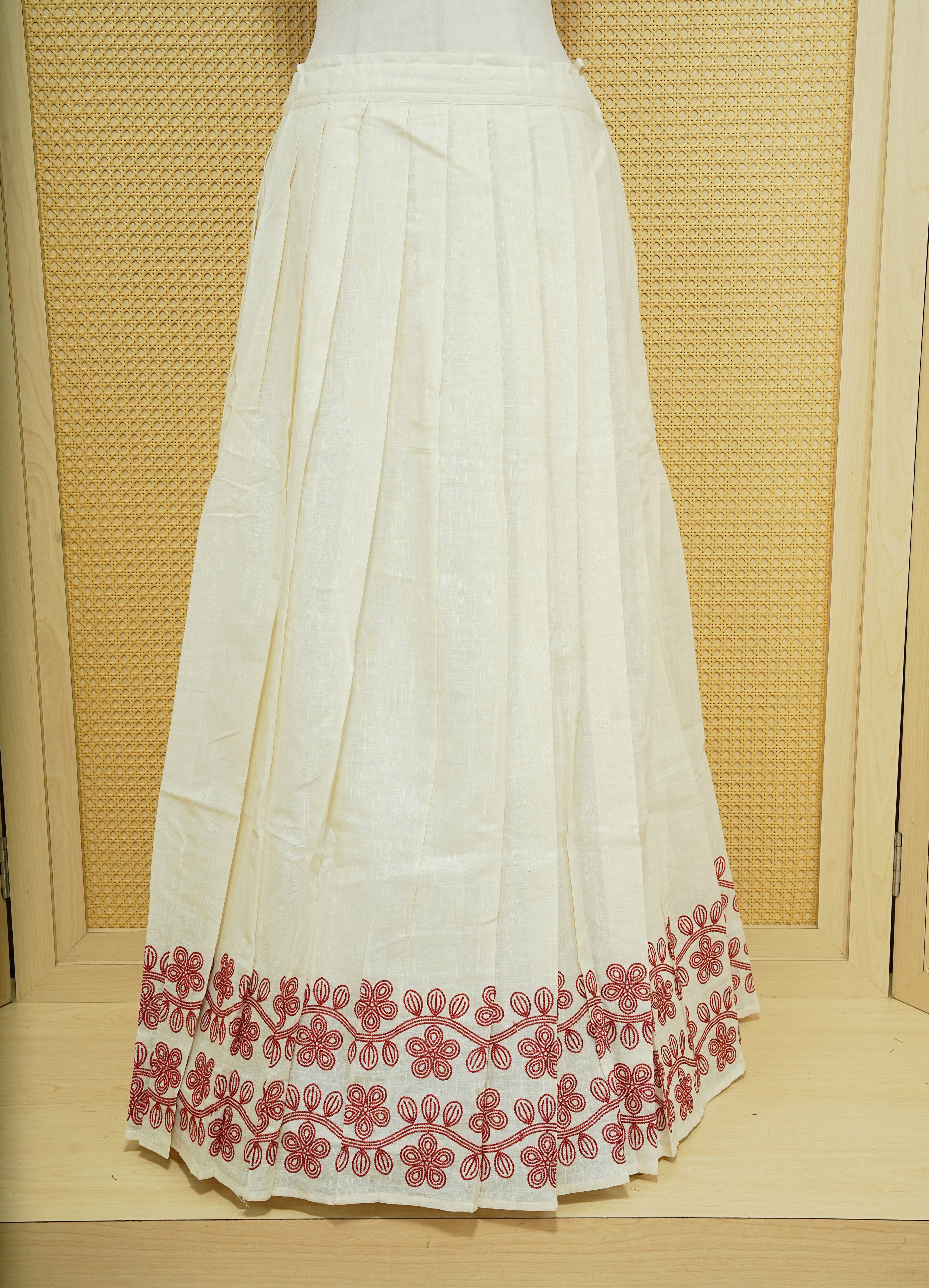 Cream colour cotton Stitched Skirt With Red colour Floral thread pattern on the border.