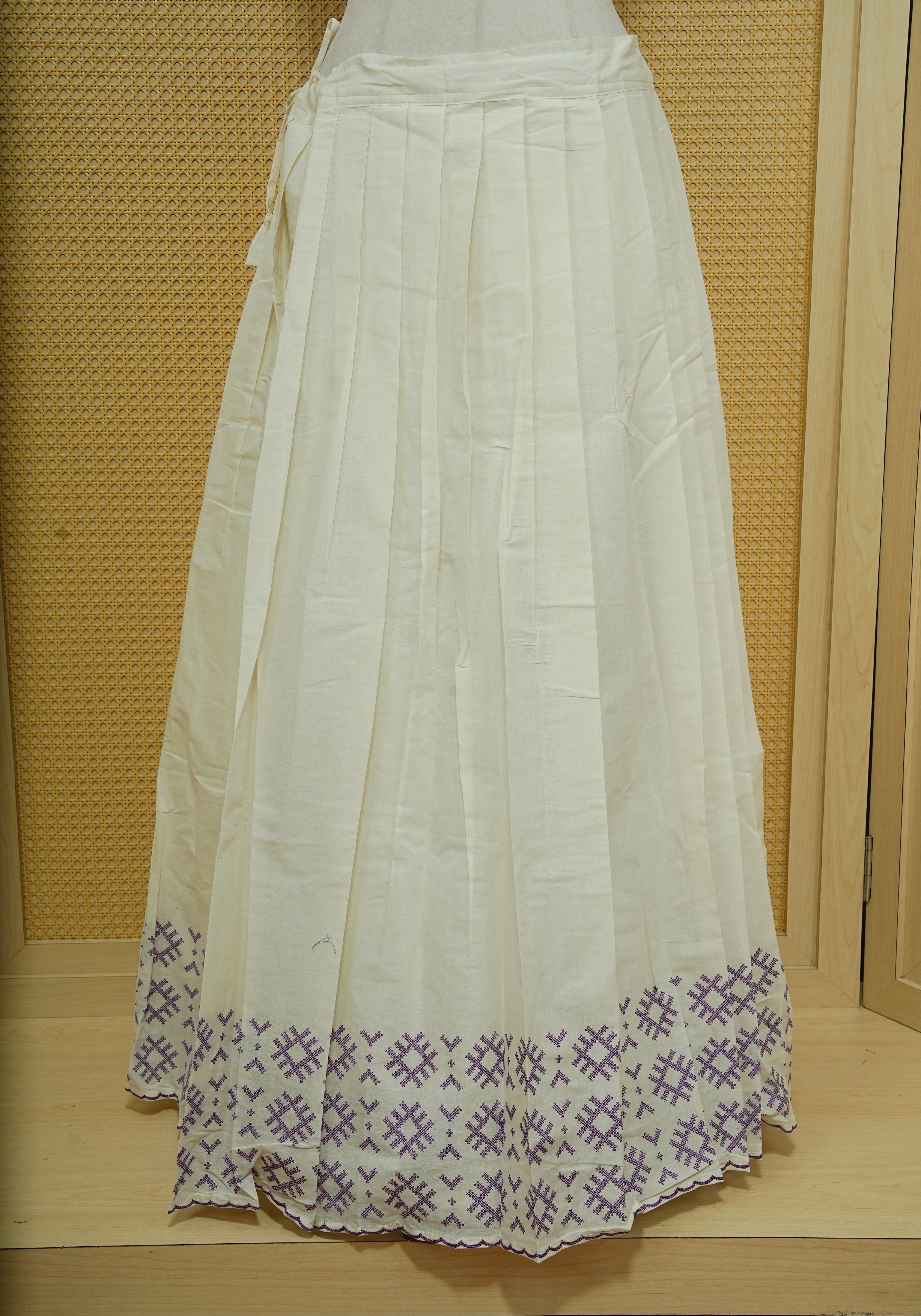 Cream colour cotton Stitched Skirt With Purple colour thread pattern Scallop border.