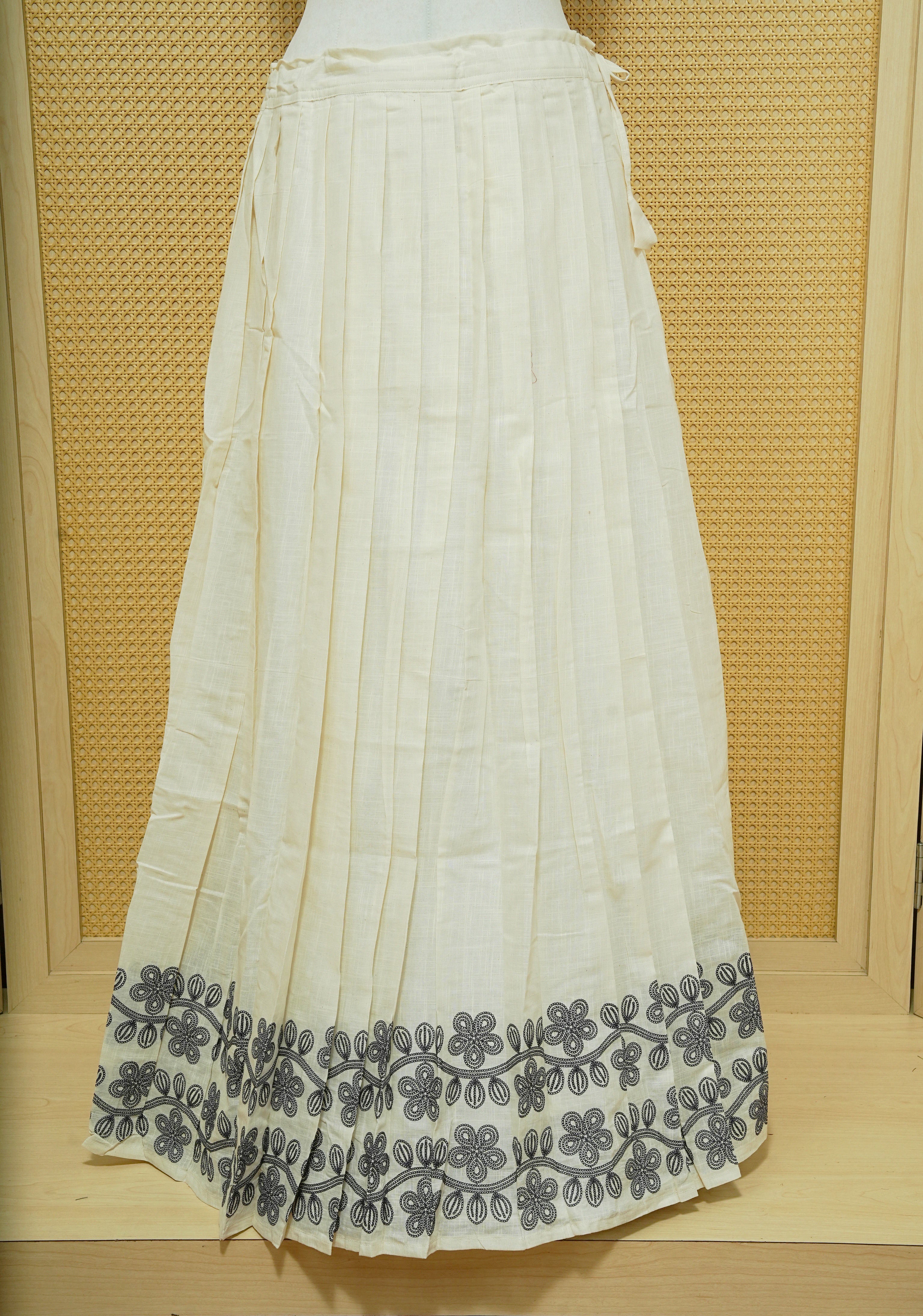 Cream colour cotton Stitched Skirt With Blue colour Floral thread pattern on the border.