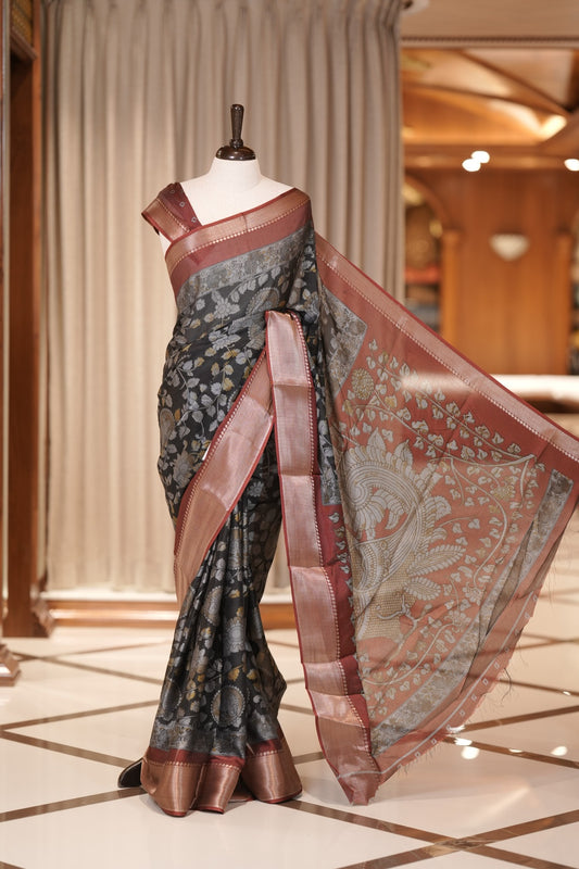 Ash & Maroon colour Kalamkari saree in Milan moss fabric featuring intricate Kalamkari print, Adorned with a rich copper zari border and stunning contrast color design on the pallu and blouse piece for a graceful look.
