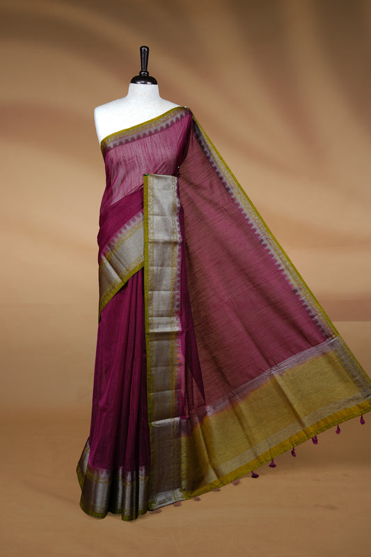 Grape colour Semi linen saree featuring Elegant plain body, complemented by contrast Green colour With Antique zari border, paired with matching blouse piece.