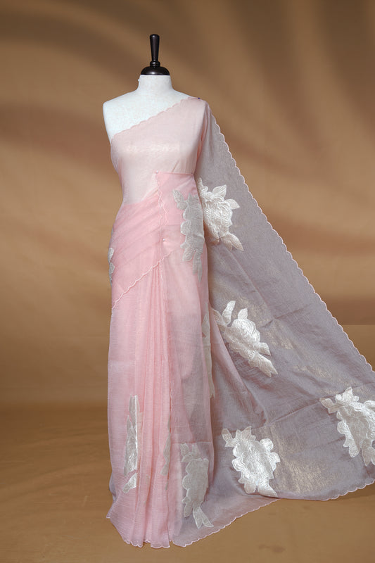 Pastel peach colour Crush Organza Saree featuring White floral Pattern on body, complemented by classy Thread border, paired with matching blouse piece.