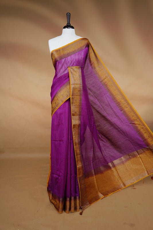 Purple colour Semi linen saree featuring Elegant plain body, complemented by contrast Mustard colour With Antique zari border, paired with matching blouse piece.