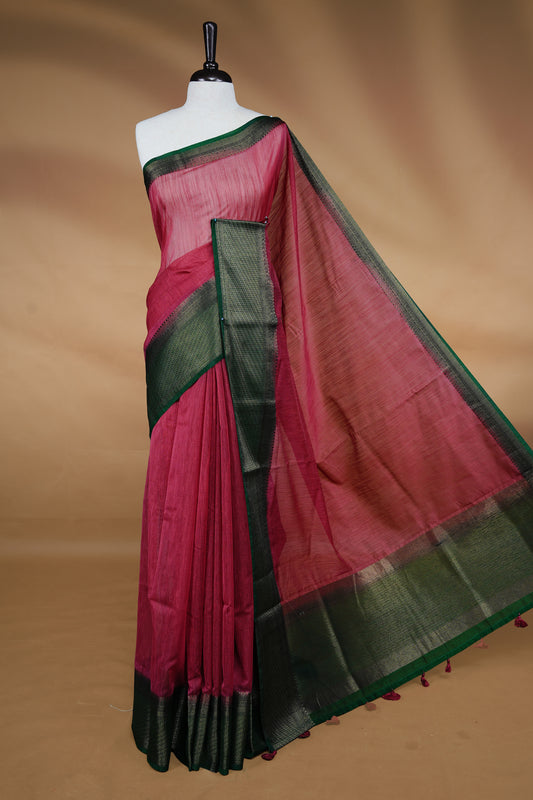 Mauve colour Semi linen saree featuring Elegant plain body, complemented by contrast Green colour With Antique zari border, paired with matching blouse piece.