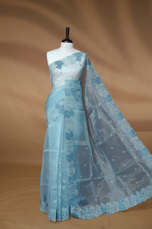 Pastel Blue colour Pure Organza Featuring Self colour Embroidery motifs on body, Enriching floral thread pattern & scalp border, paired with matching blouse piece.