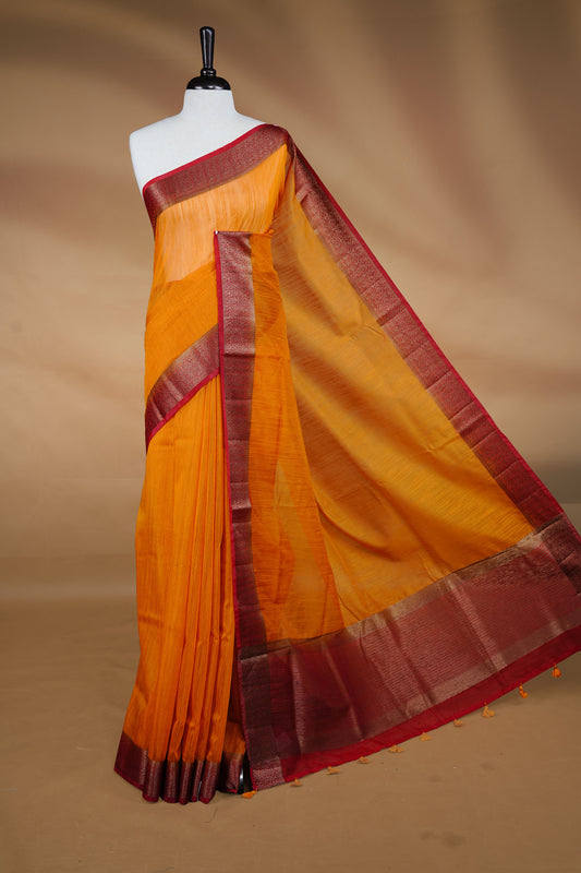 Mustard colour Semi linen saree featuring Elegant plain body, complemented by contrast Maroon colour With Antique zari border, paired with matching blouse piece.