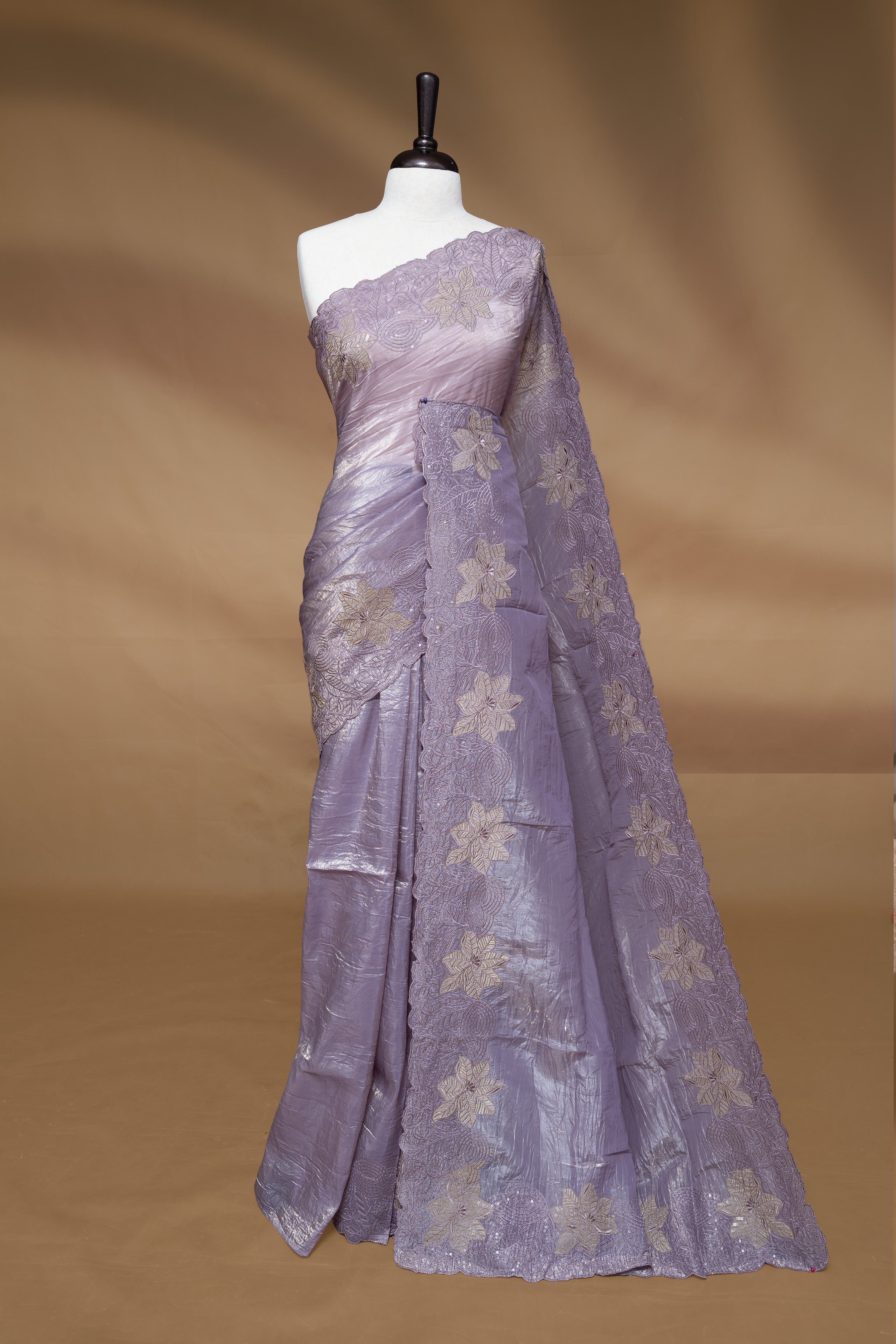 Pastel Purple colour Crush Organza Featuring Plain body, Enrich with Floral thread pattern with sequins & scalp border, paired with matching blouse piece.