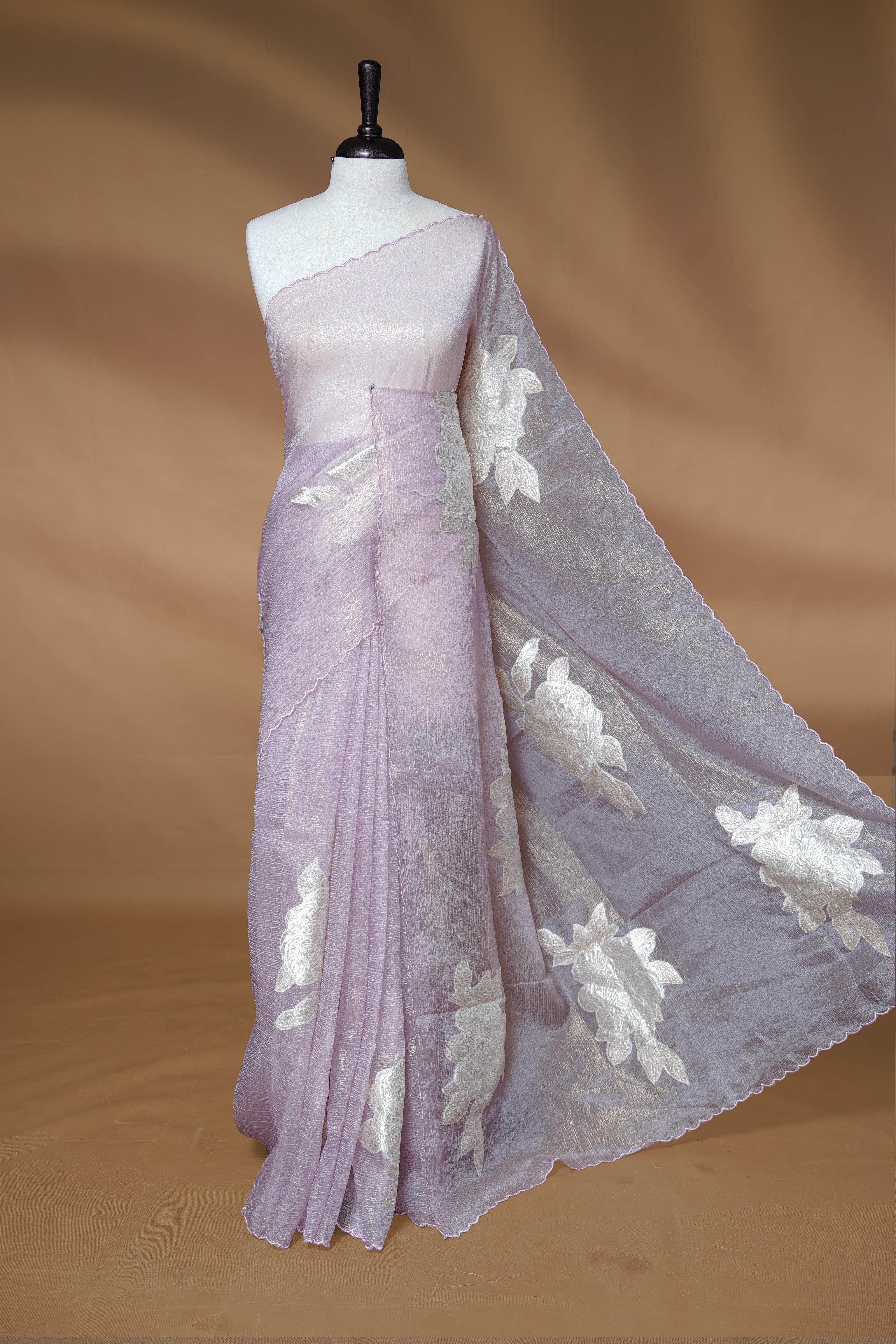 Pastel purple colour Crush Organza Saree featuring White floral Pattern on body, complemented by classy Thread border, paired with matching blouse piece.
