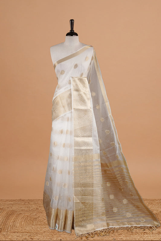White Colour Semi Organza Saree Featuring Elegant Gold zari Check with motifs on body, Traditional border, comes with matching blouse piece.