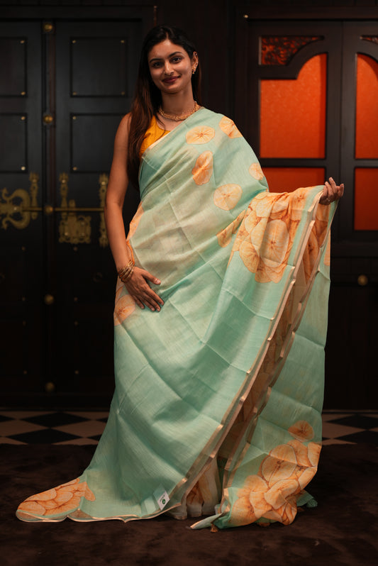Sea Green colour Semi Linen saree featuring Banana Chips Print with Gold Tissue Border, comes with tassels.