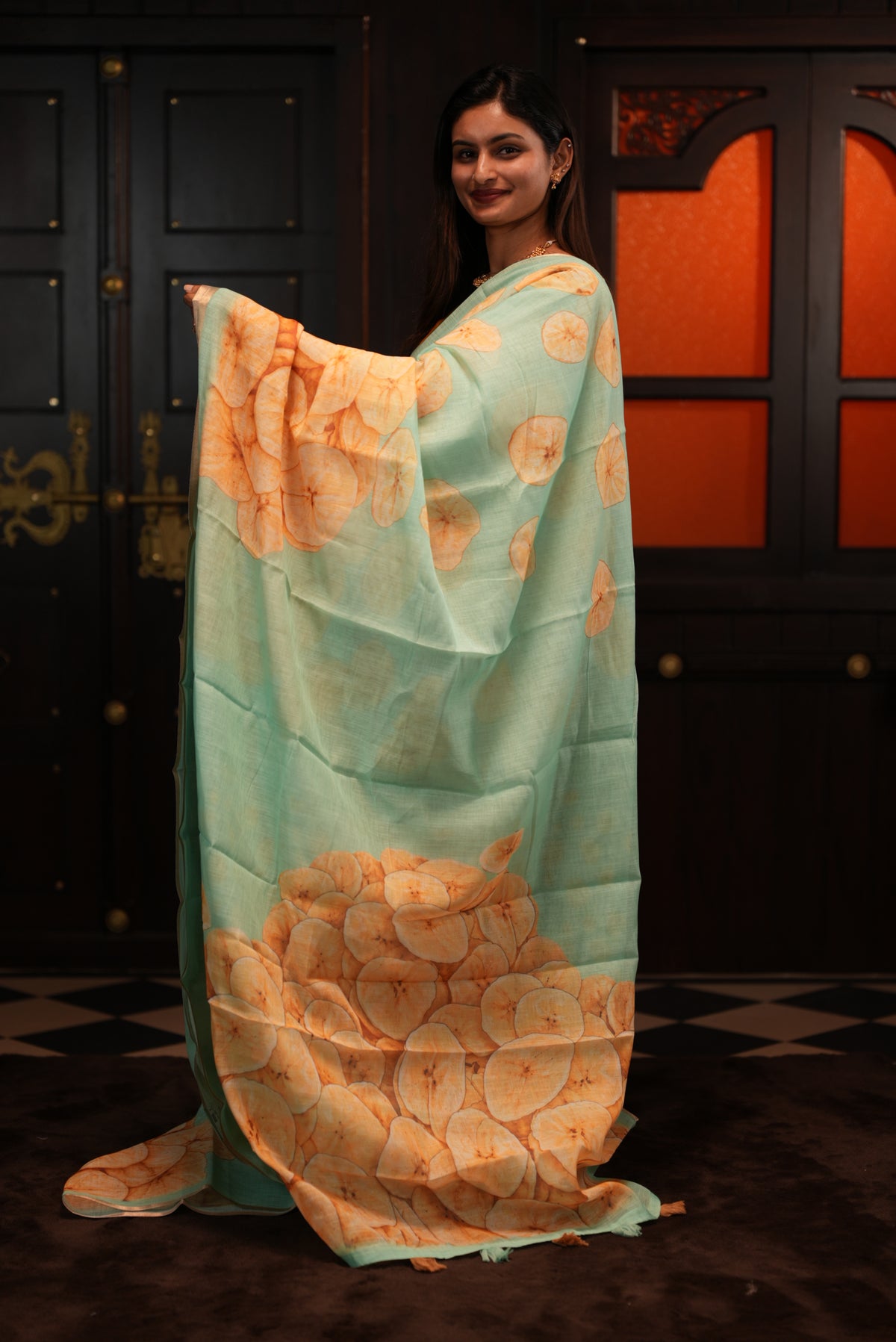 Sea Green colour Semi Linen saree featuring Banana Chips Print with Gold Tissue Border, comes with tassels.