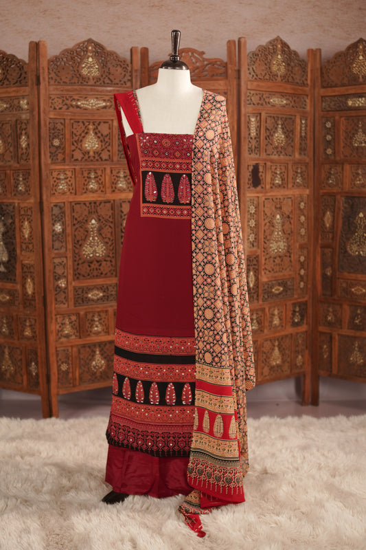 Maroon colour georgette salwar material featuring Daman Print Detailing Mirror work on neck portion, a dupatta with Same print , and Shantoon bottom.