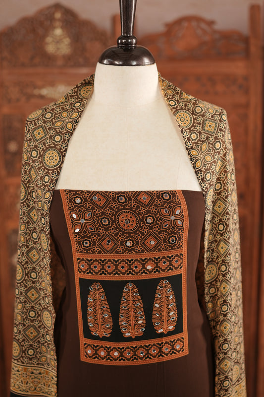 Coffee Brown colour georgette salwar material featuring Daman Print Detailing Mirror work on neck portion, a dupatta with Same print , and Shantoon bottom.