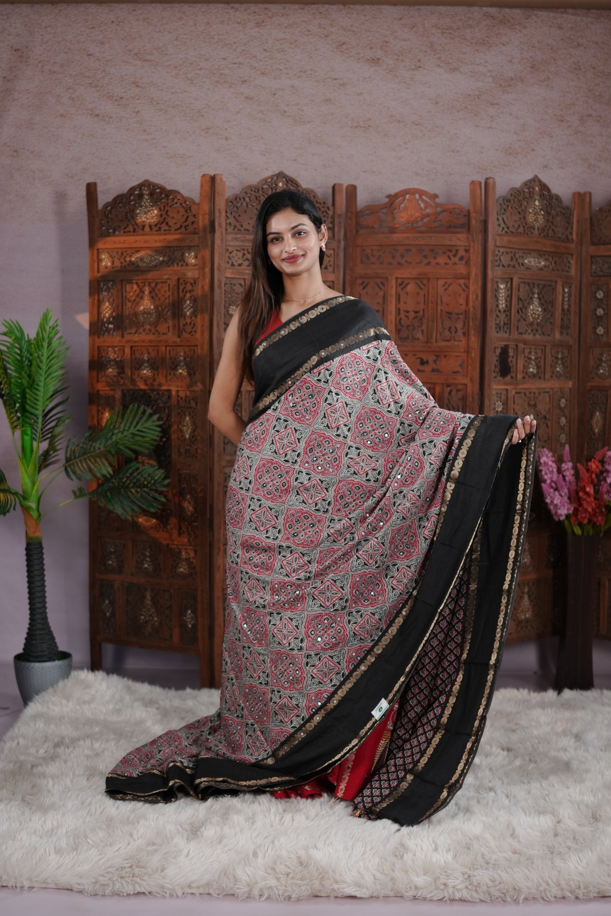 Black Colour Manipuri saree with Ajrakh print with delicate mirror work body, double border, jhumka tassels, matching blouse piece.