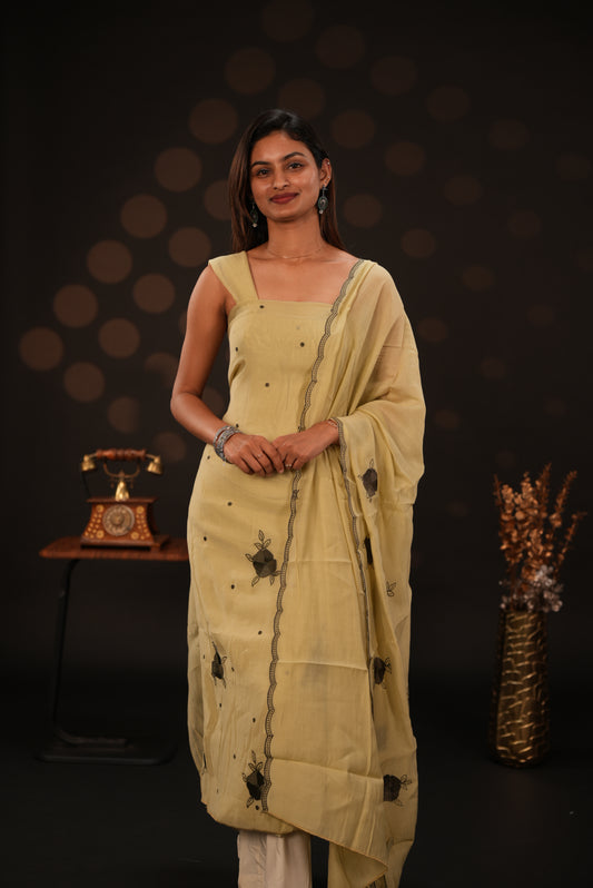 Pastel yellow colour mul chanderi salwar material featuring Floral & dot Thread embroidery body and border, paired with Same design with scallop border dupatta and santoon material bottom