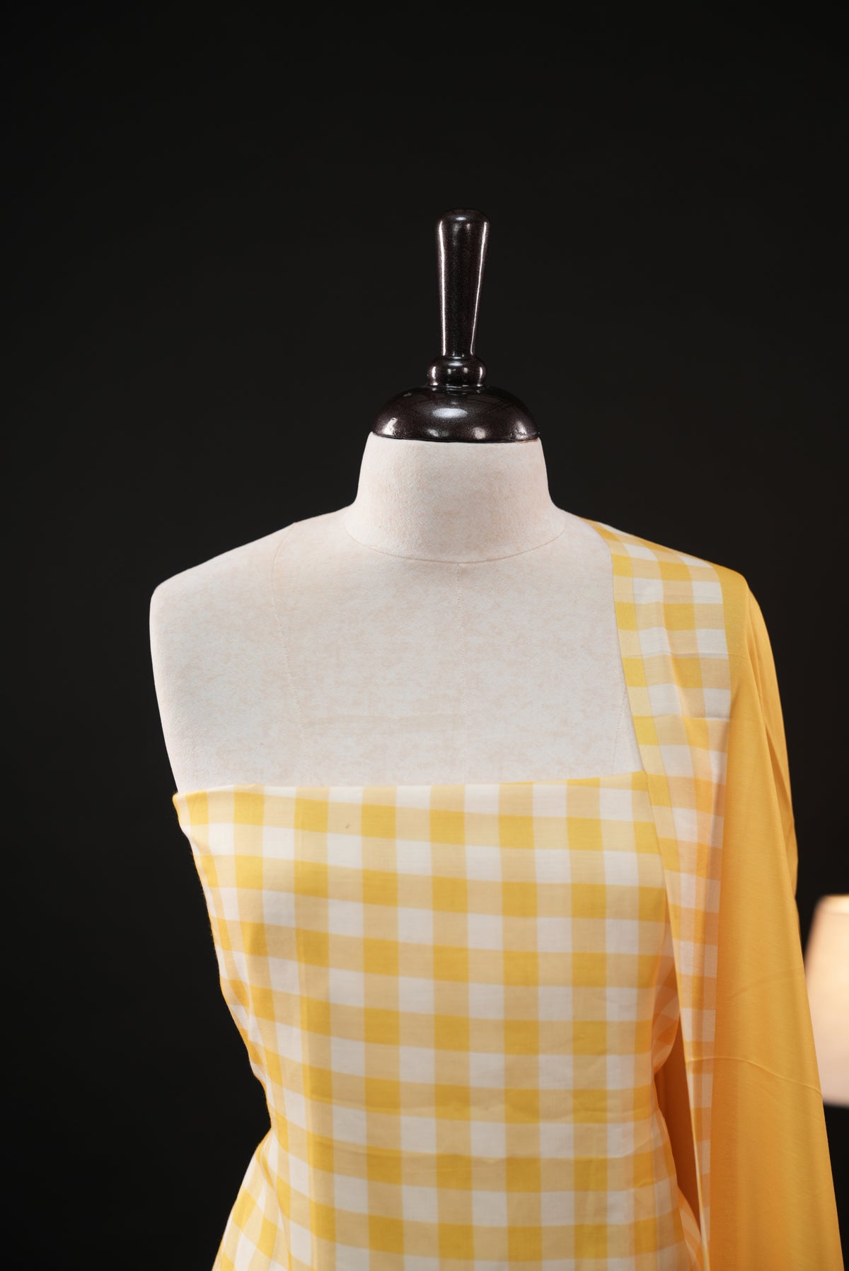 Yellow colour checked Mul Chanderi salwar material, paired with a matching bottom and dupatta.