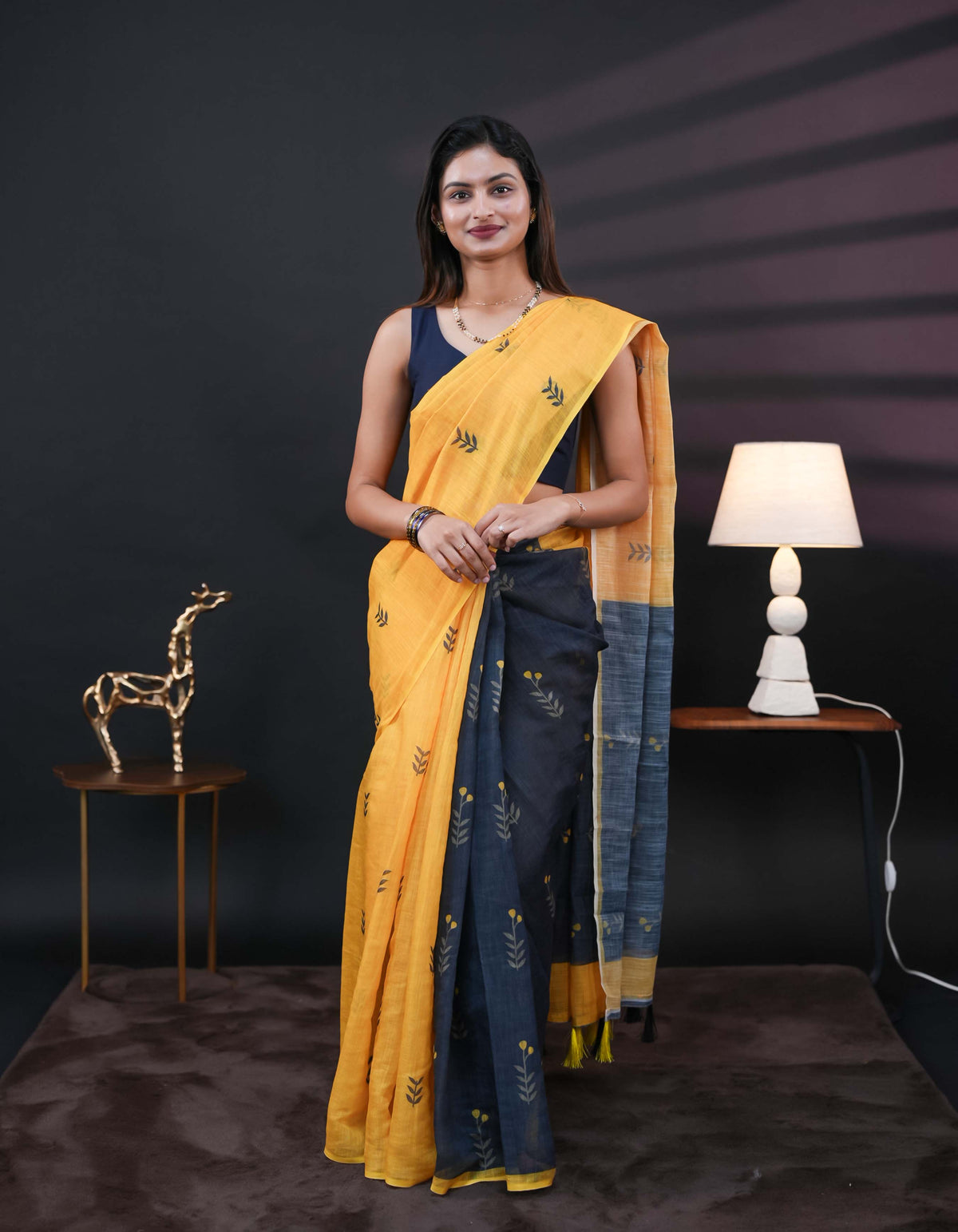 Yellow and black half and half semi linen saree having leaf and floral prints on body
