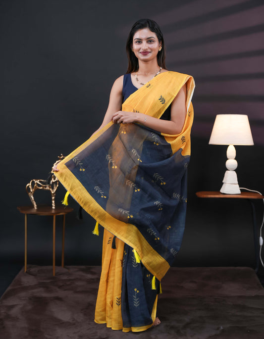 Yellow and black half and half semi linen saree having leaf and floral prints on body