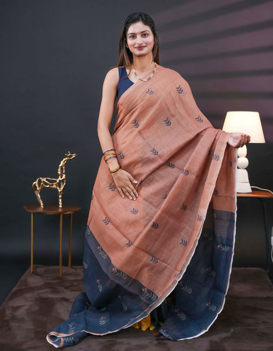 Chikku and black half and half semi linen saree having leaf and floral prints on body, contast colour printed pallu with tassels comes with matching Blouse Piece