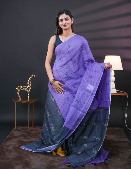 Violet and black half and half semi linen saree having leaf and floral prints on body, contast colour printed pallu with tassels comes with matching Blouse Piece
