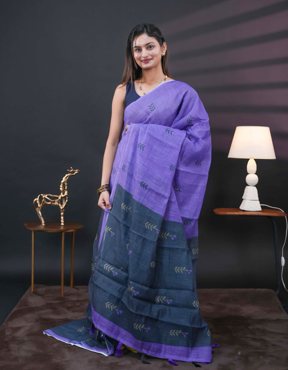 Violet and black half and half semi linen saree having leaf and floral prints on body, contast colour printed pallu with tassels comes with matching Blouse Piece