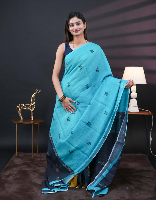Aqua Blue and black half and half semi linen saree having leaf and floral prints on body