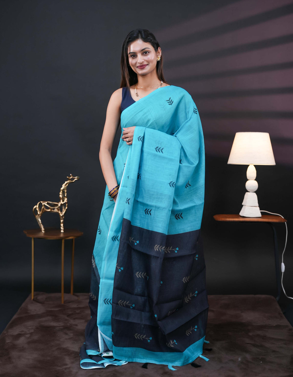 Aqua Blue and black half and half semi linen saree having leaf and floral prints on body