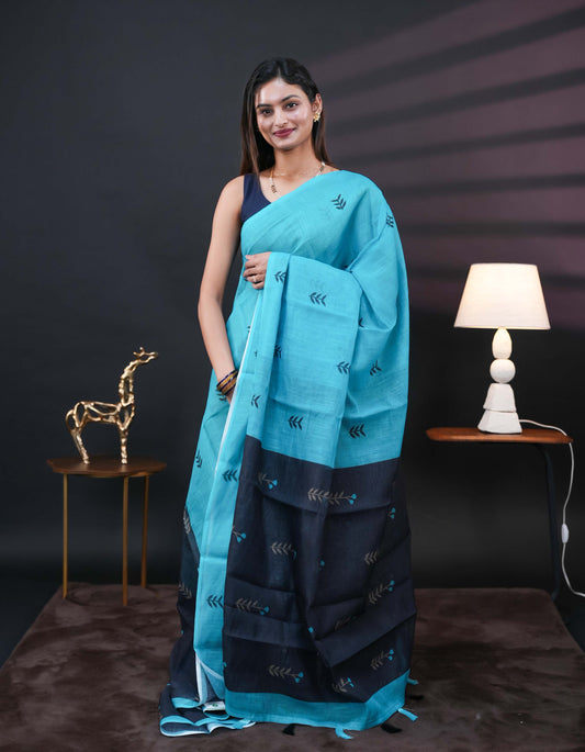 Aqua Blue and black half and half semi linen saree having leaf and floral prints on body