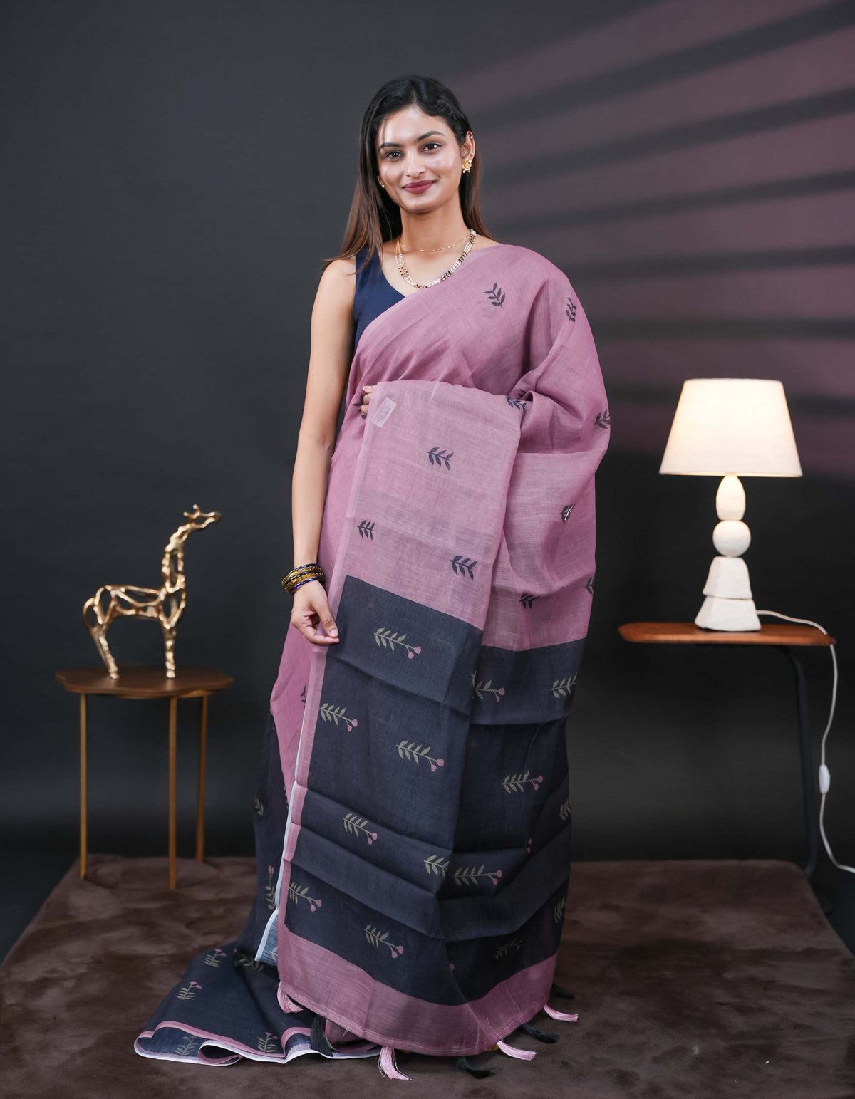 Onion Pink and black half and half semi linen saree having leaf and floral prints on body