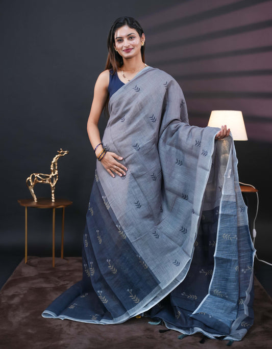 Grey and black half and half semi linen saree having leaf and floral prints on body