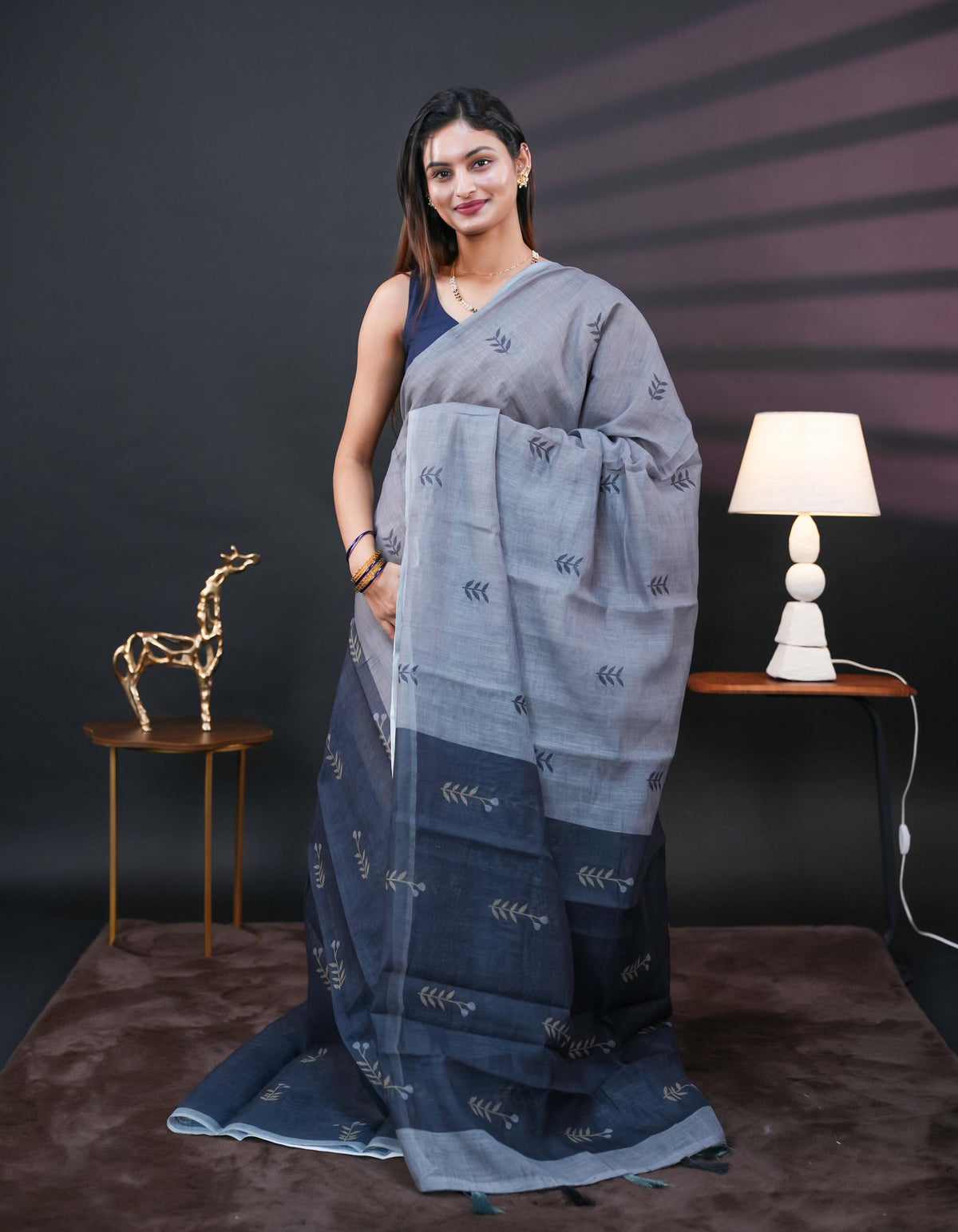 Grey and black half and half semi linen saree having leaf and floral prints on body