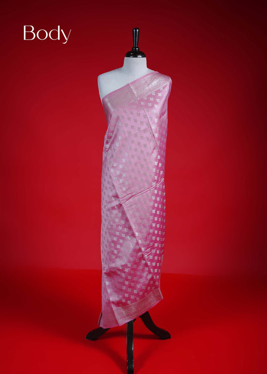 Pink colour Banarasi soft silk saree adorned with silver zari buttas, featuring intricate silver zari detailing and beautifully finished pallu with tassels. Paired with a matching blouse piece.