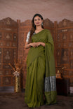 Olive Green Colour Soft Cotton Saree featuring a plain body, complemented by a striped pallu with tissue detailing, paired with a matching blouse piece.