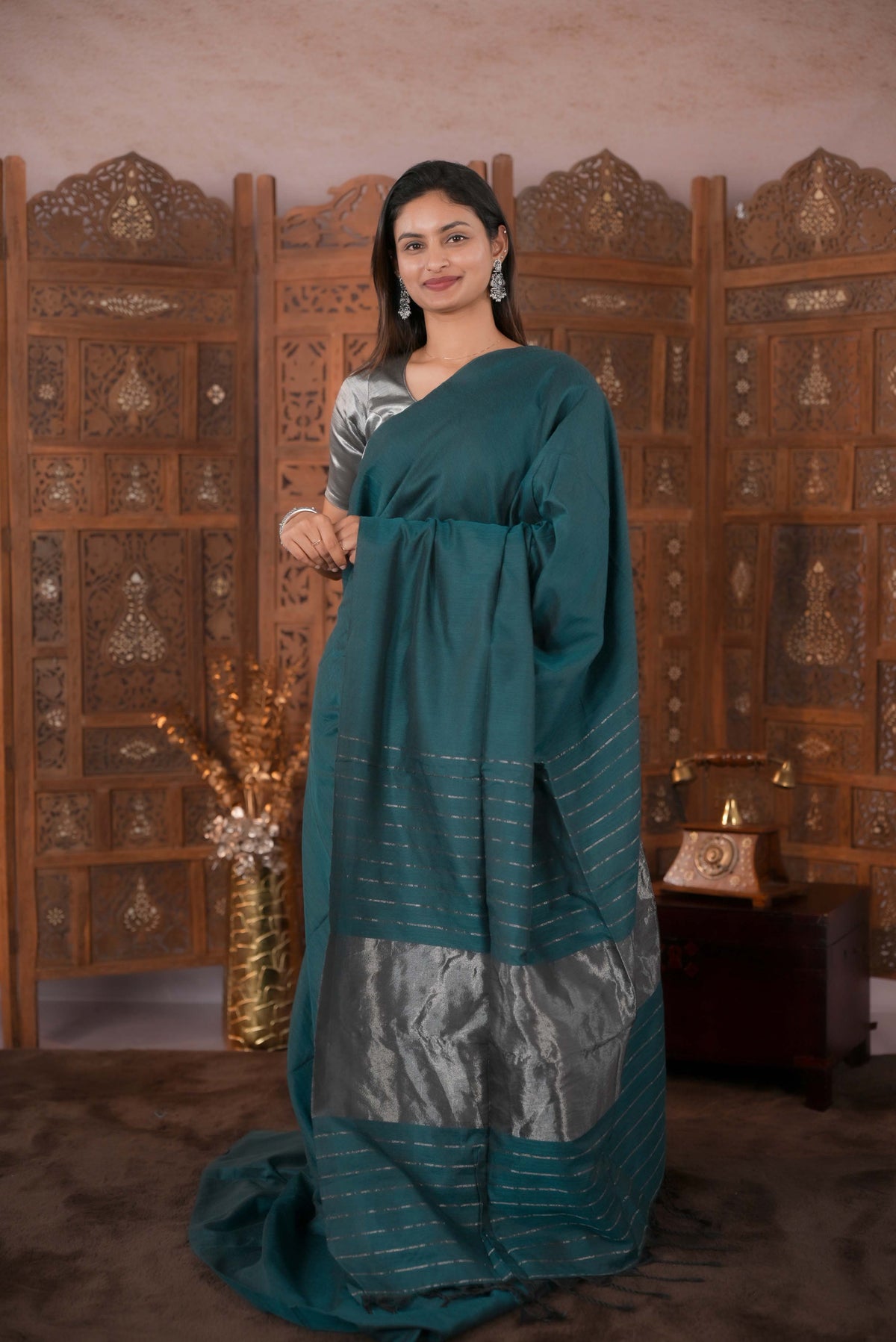 Bottle Green Colour Soft Cotton Saree featuring a plain body, complemented by a striped pallu with tissue detailing, paired with a matching blouse piece.