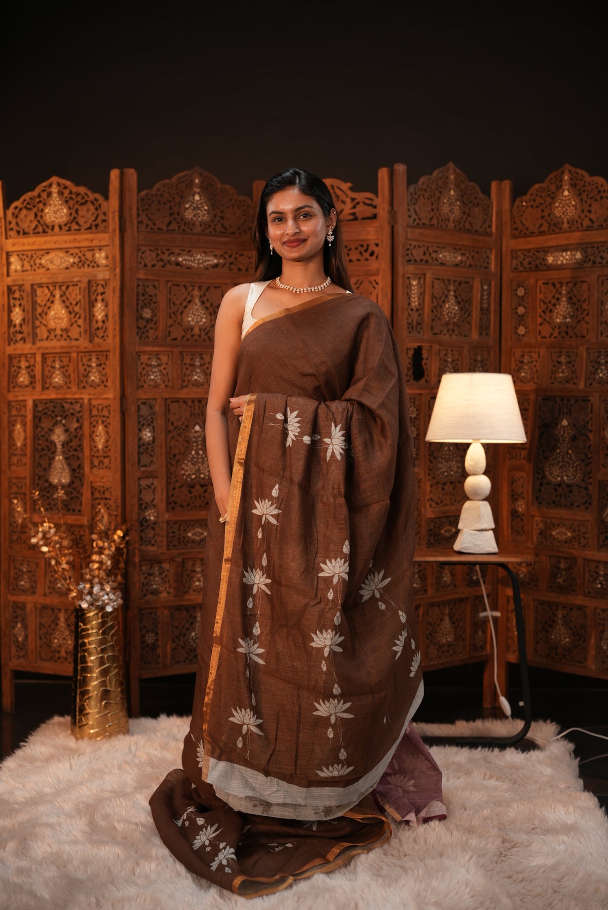 Coffee Brown colour Semi Linen saree featuring plain & lotus print, Bavanchi border & same print on Pallu, comes with contrast colour blouse piece.