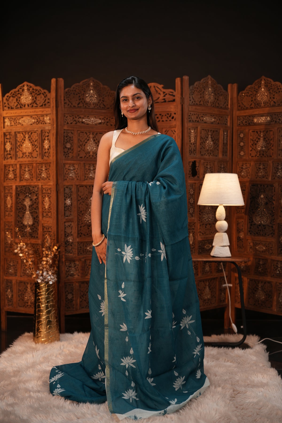 Peacock Green colour Semi Linen saree featuring plain & lotus print, Bavanchi border & same print on Pallu, comes with contrast colour blouse piece.