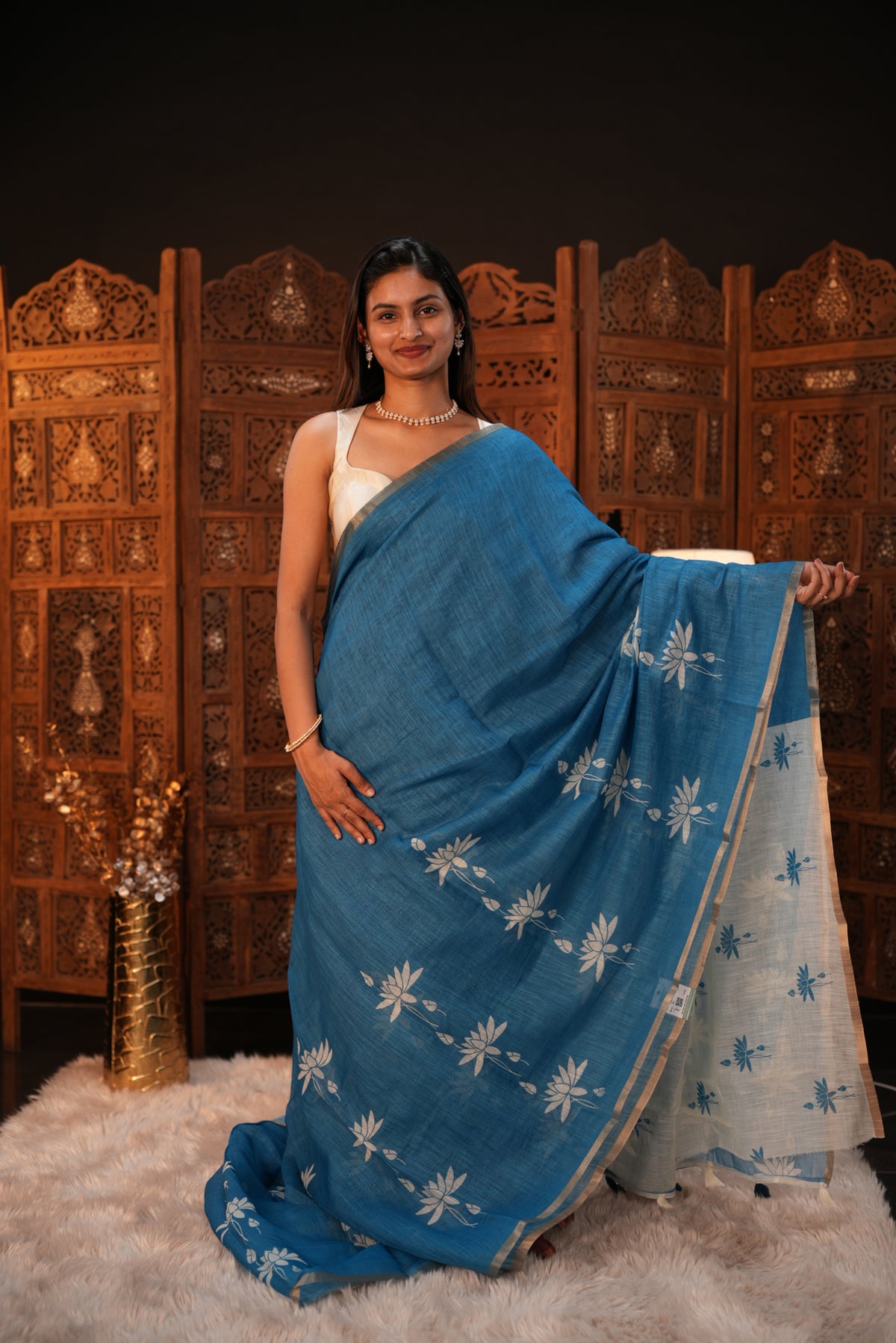 Sky Blue colour Semi Linen saree featuring plain & lotus print, Bavanchi border & same print on Pallu, comes with contrast colour blouse piece.