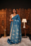 Sky Blue colour Semi Linen saree featuring plain & lotus print, Bavanchi border & same print on Pallu, comes with contrast colour blouse piece.